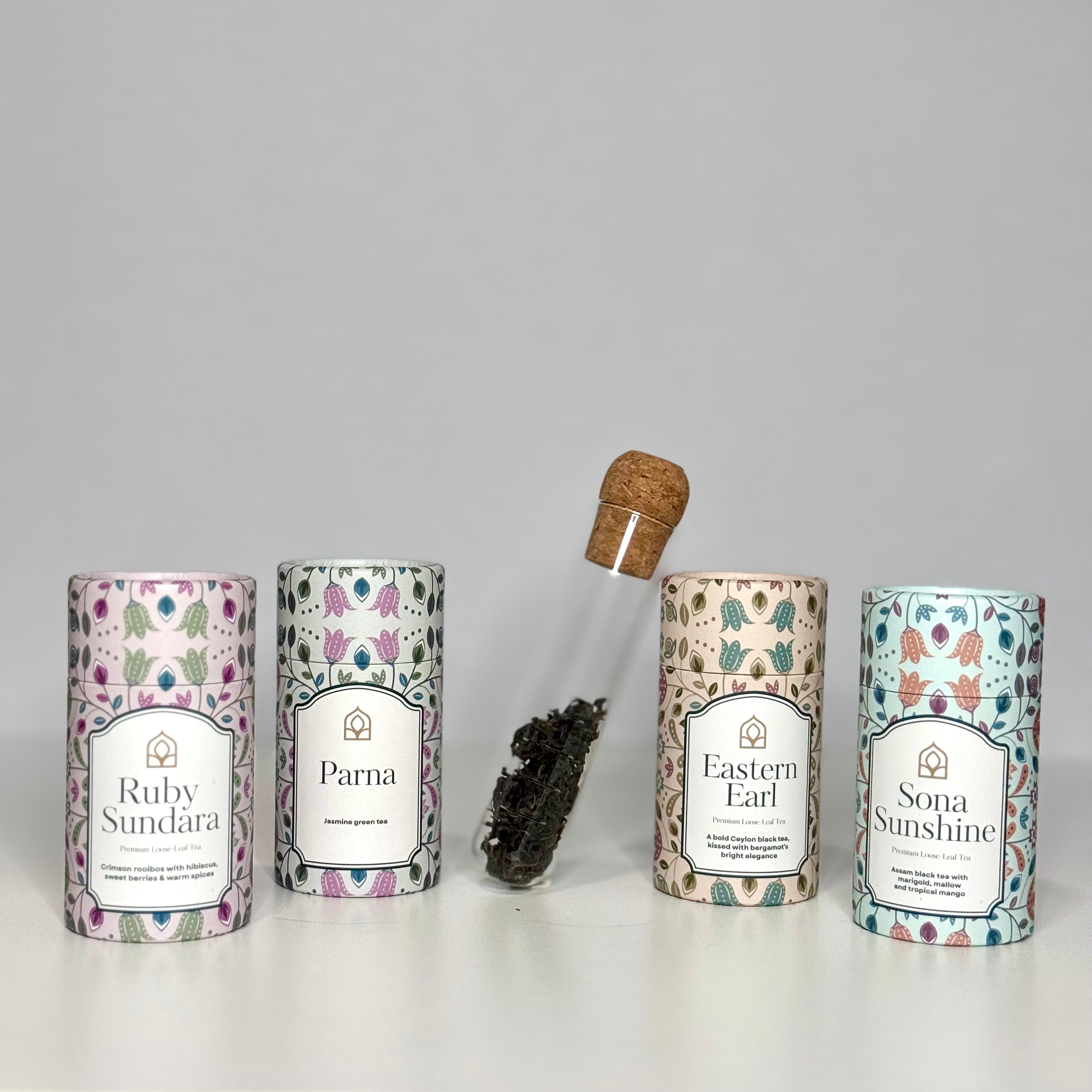 Four premium loose leaf teas in elegant canisters — Chai's curated tea gift collection