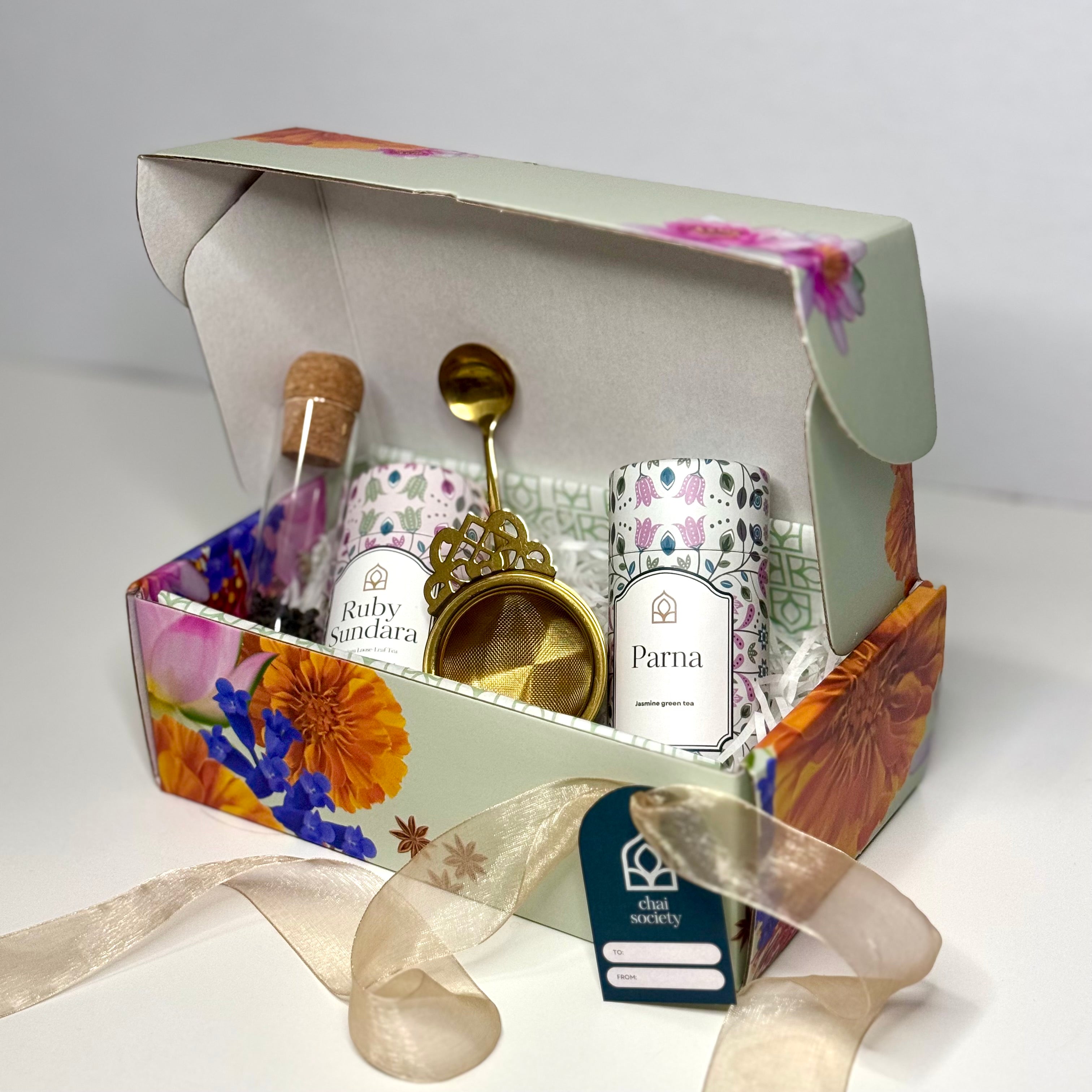 Chai's luxury loose leaf tea gift box with Parna and Ruby Sundara teas, glass infuser, gold strainer and gold spoon with ribbon and gift card