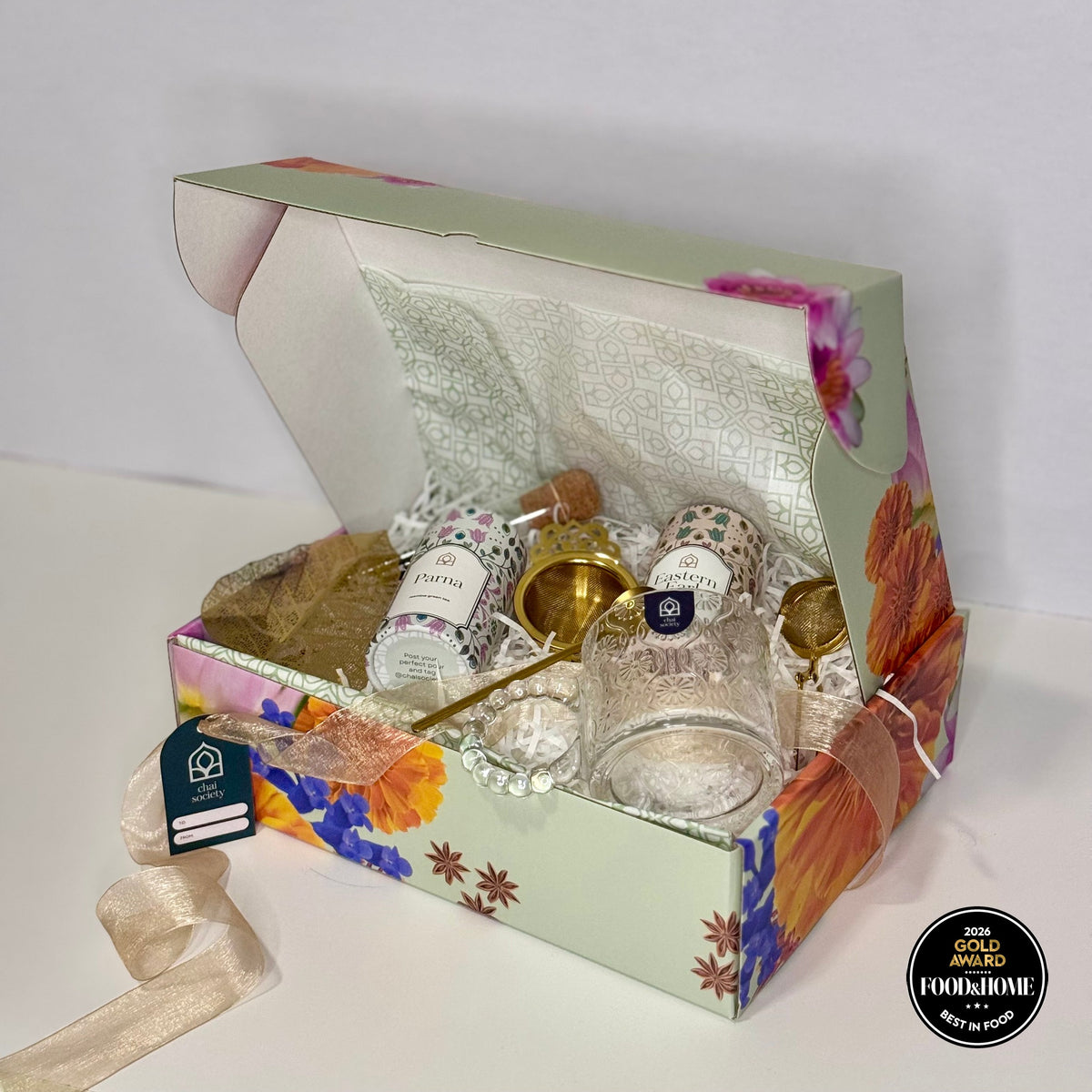 A quiet, hand-crafted tea gift box arranged simply, offering a gentle gesture of comfort for a hard week